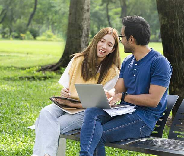 students sitting in a bench talking